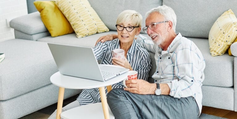 Elderly Couple Reviewing Assisted Living Facility Floor Plan Online